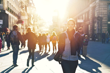 Urban girl striding through city area