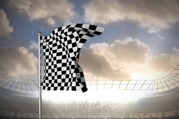 Poster - Checkered flag against large football stadium under cloudy blue sky