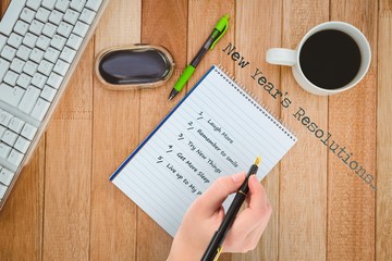 Poster - Businesswomans hand writing with fountain pen against business desk with computer and coffee
