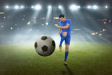 Fototapeta Młodzieżowe - Young asian football player shooting the ball