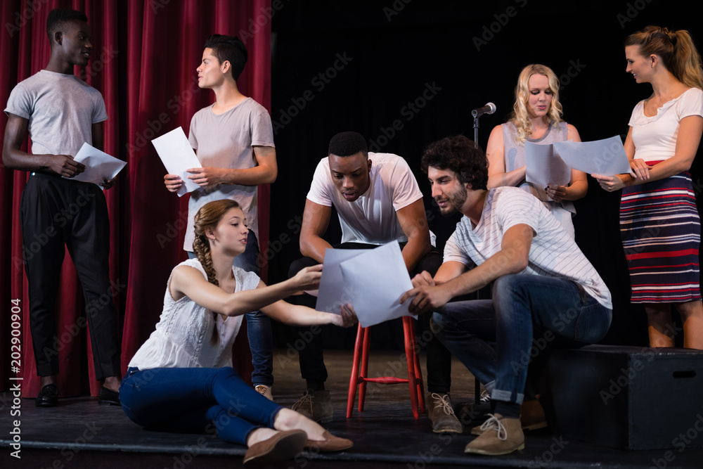 Actors reading their scripts on stage - obrazy, fototapety, plakaty 