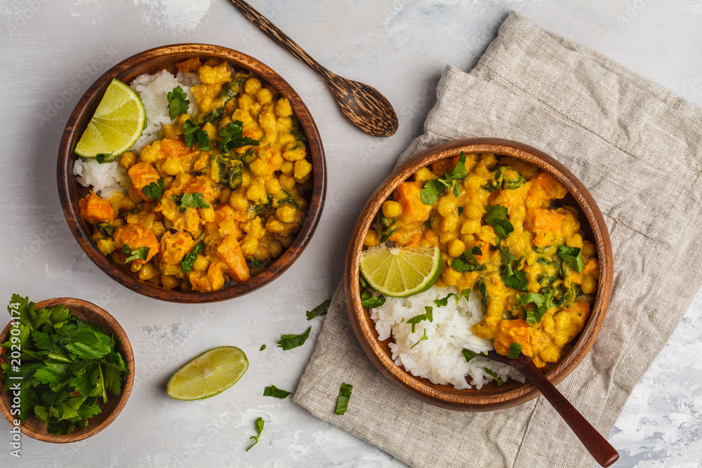 Vegan Sweet Potato Chickpea curry in wooden bowl on light background, top view, copy space. Healthy vegetarian food concept. - obrazy, fototapety, plakaty 