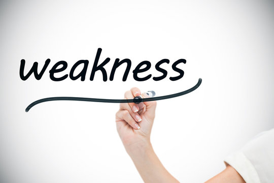 Businesswoman writing the word weaknesses against white background with vignette