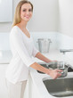© WavebreakmediaMicro - Happy gorgeous woman filling pan with water