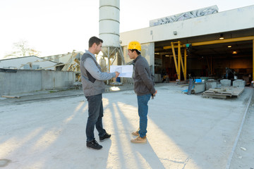 two workers workers near warehouse