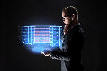 Canvas Print - architecture, technology and construction concept - businessman with transparent tablet pc computer and virtual building blueprint projection