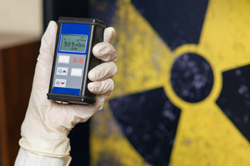 Geiger counter with radioactive materials in the background