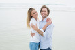 © WavebreakmediaMicro - Happy romantic couple embracing at beach