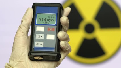 Sticker - Radiation supervisor in glove with geiger counter checks the level of radiation