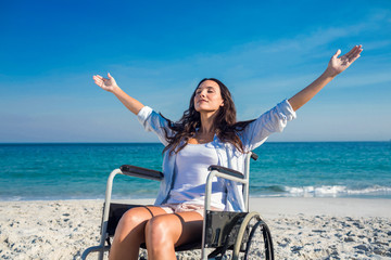 Wall Mural - Disabled woman with arms outstretched at the beach