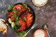Tandoori Chicken whole with naan, raita and pilau rice, top view, blank space