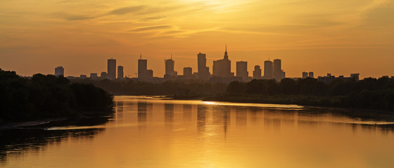 Wall Mural - Evening panorama of Warsaw skyline over Vistula river at sunset, Poland