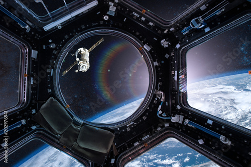 Fotomural View from a porthole of space station on the Earth background