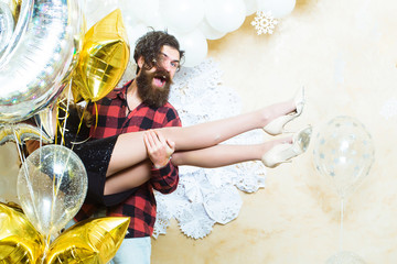 Poster - Bearded man smile with woman in hands on christmas. Hipster and woman on new year or xmas eve. Couple in love enjoy holiday party celebration. Happy family celebrate christmas and new year