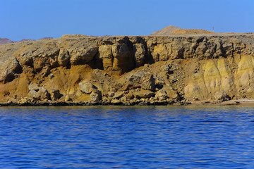 Elevated above sea level, beautiful coral reefs the form mountains and rocks against the blue sky and clear sea water coast of the unique Ras Mohammed nature reserve. Magnificent diving, summer, rest.