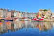 Honfleur harbour in Normandy France. Color houses and their reflection in water.