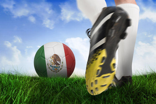 Composite image of football boot kicking mexico ball against field of grass under blue sky