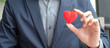 © Jo Panuwat D - Businessman hand holding Red heart