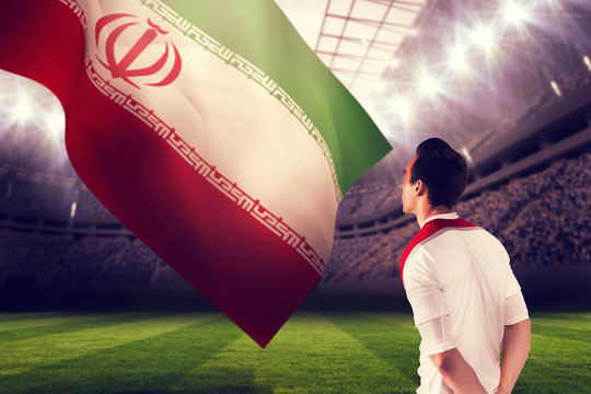 Handsome football fan looking ahead against football stadium