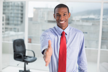 Poster - Elegant smiling Afro businessman offering handshake at office