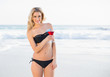© WavebreakmediaMicro - Gorgeous blonde in elegant bikini holding cocktail