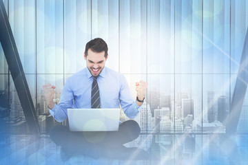 Poster - Businessman sitting with his laptop cheering against window overlooking citty