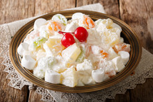 Fruit Salad From Pineapple, Oranges, Grapes And Coconut With Marshmallow And Vanilla Yogurt Close-up. Horizontal