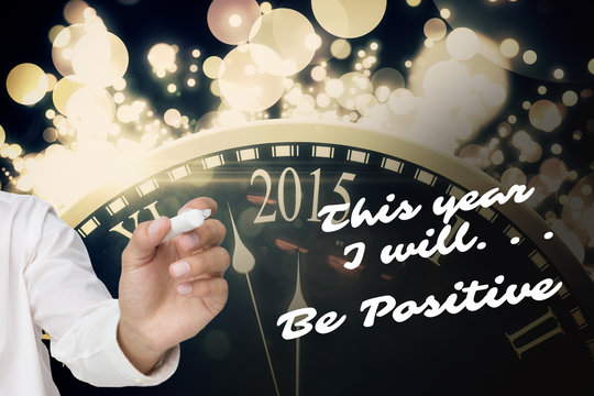 Businessman about to write something against black and gold new year graphic