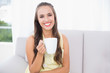 © WavebreakmediaMicro - Cheerful young brunette holding a mug