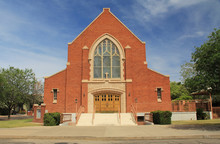 Red Brick Exterior Of Grace Evangelical Lutheran Church In Tucson, Arizona With Blue Sky Copy Space,  Stained Glass Windows.