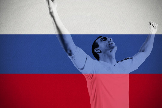 Excited football fan cheering against russia national flag