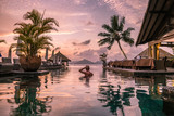 young man at the beach during vacation at the tropical islands of the Seychelles, men in infinity pool during sunset at the Seychelles La Digue Island