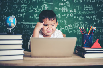 Wall Mural - kid  use computer laptop  in the classroom.