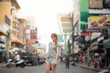 © Alvaro Hernandez/ADDICTIVE STOCK - Attractive woman on crowded street in Thailand