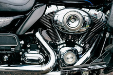 Closeup Of Motorbike With Lots Of Chrome Details. Modern Powerful Perfomance Road Motorcycle Shiny Reflexive Surface Engine With Exhaust Pipes.  Vehicle Industry.  Two-wheeled Vehicle Technologies.