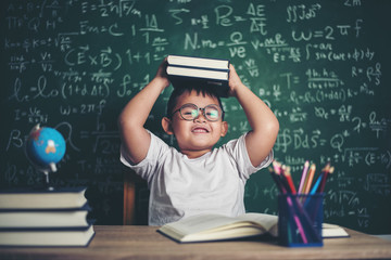 Wall Mural - boy with books sitting in the classroom