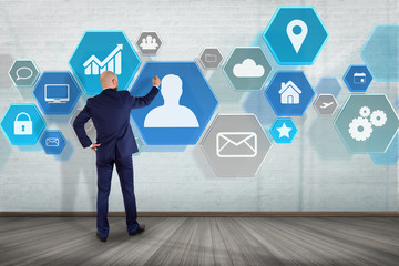 Poster - Businessman in front of a wall with Business network interface