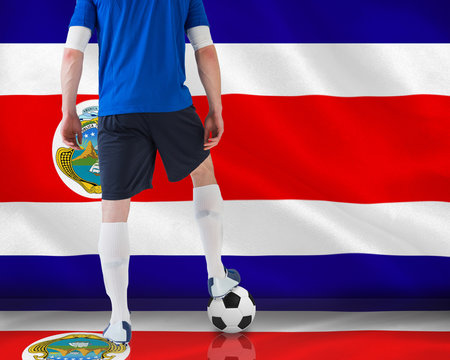 Handsome football player in blue jersey against costa rica national flag