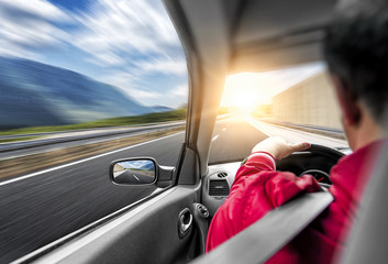 The driver rushes by car along the road. Speed race in motion.