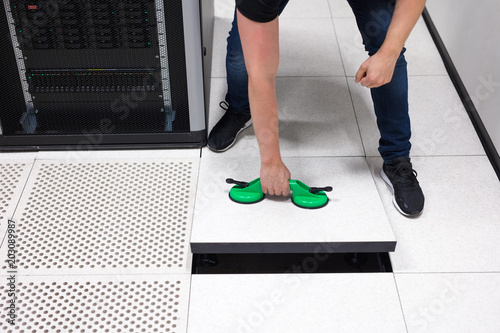 It Engineer Pulling Floor Tile Using Suction Cups In Datacenter It Engineer Pulling Floor Tile Using Suction Cups In Datacenter