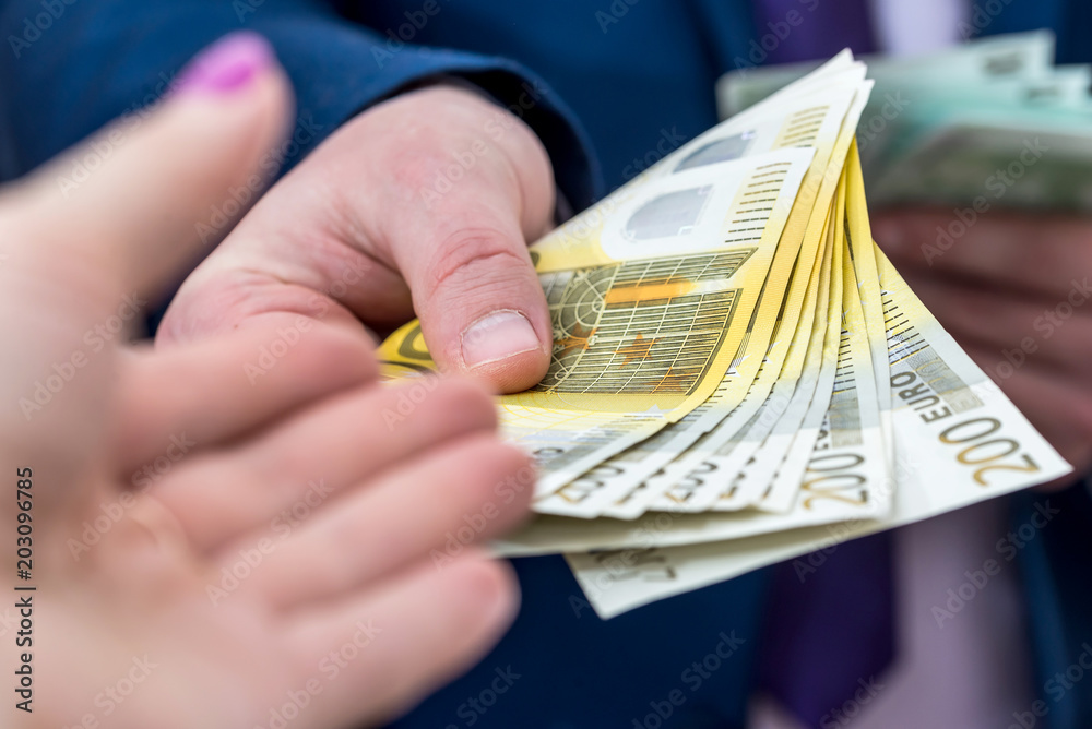 Businessman in suit offer euro banknotes, close up