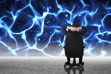 Poster - Businessman sitting in swivel chair  against glowing blue lights over desert
