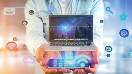 Poster - Businessman using a smartphone with a Computer surrounding by app and social icon - 3d render
