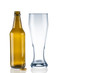 Empty beer bottle and tumbler on white background