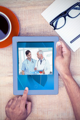 Poster - View of video chat app against cropped image of person using on digital tablet