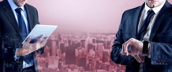 Poster - Businessman checking the time on watch against high angle view of city