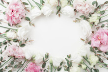 Beautiful Floral Frame Of Pastel Flowers And Eucalyptus Leaves On White Table Top View. Flat Lay Style.