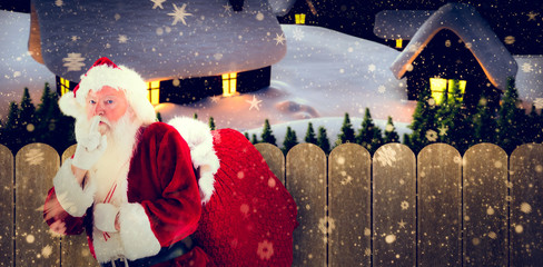 Poster - Santa asking for quiet with bag against purple sky over fence