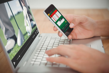 Poster - View of lecture app against man holding mobile phone while typing on laptop at desk