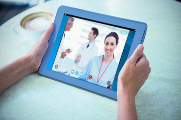 Poster - View of video chat app against person holding tablet computer at table in cafe